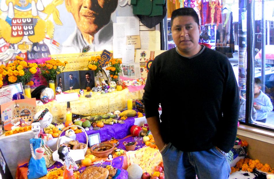 Jair Andrade stood in front of the "ofrenda" at the shop he owns.