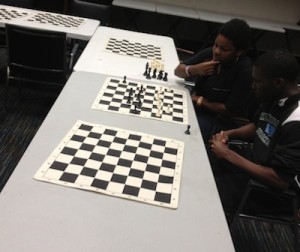 Two Lenfest kids get ready for chess club with a practice match.