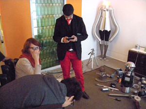 Viewers of Vazquez's work, including Nestor Tamayo, dressed in red pants and a black blazer. 