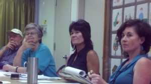 President Ruth Seeley, Barbara McCabe and Secretary Angela Miles listen to Yomi Awodesu discuss the benefits of youth soccer in Germantown.