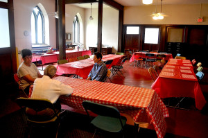 Parishioners from St. Timothy's Church help set up tables for the picnic following the parade.