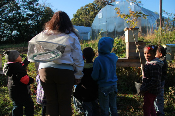 Beekeeper Anaiis Salles teaches children about beekeeping at the High Point Farm on Awbury Arboretum. 