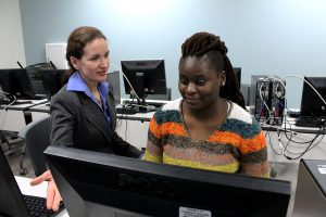 Paula Umana (left), director of Single Stop at Community College of Philadelphia, helps Erica Carter (right) sign up for health insurance in the colleges Bonnell building on Spring Garden Street, in Philadelphia.