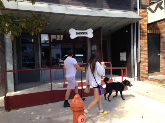 Residents of Northern Liberties walking into Dog School to benefit from all the services they provide.