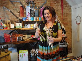 Mary going through handmade wooden kitchen spoons with carved faces.