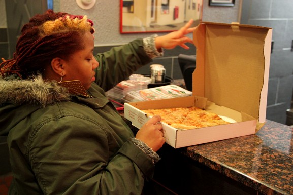 MaehrerWingateSpring2015WolfStreetPizzaWomanLookingAtPizza10