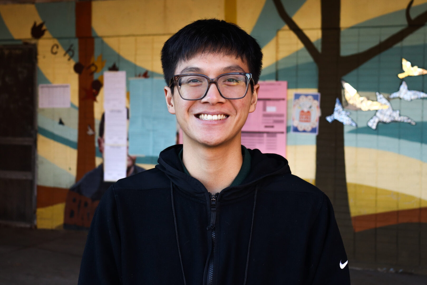 Johnnie Tran, 23, poses outside before going to help work at the polls at the Amos Recreation Center in North Philadelphia on Tuesday, Nov. 11, 2025. Tran stated, “I’m helping the election.”