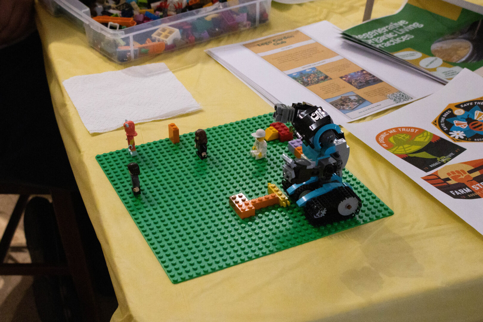 The LEGO building table with some LEGOs built on a green LEGO base. 